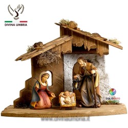 Statue of the Holy Family in the hut made of hand-carved wood